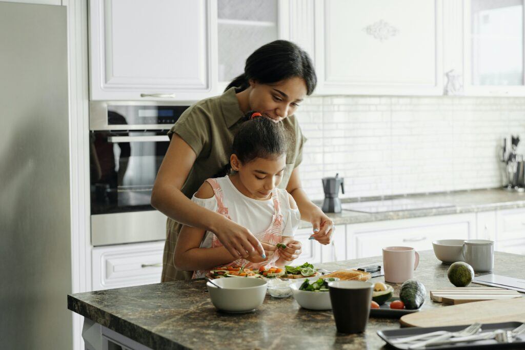 Make money online from cooking - Mom and her young daughter cooking together