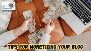 Monetize your blog - someone counting cash on their desk in front of their computer