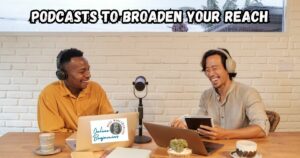 Podcasts to Broaden Your Content Reach featured image showing two men sitting at a table in front of a microphone producing a podcast.