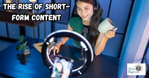 The Rise of Short-Form Content featured image showing a young lady creating a short-form video at her desk with her smartphone.